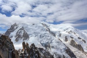 Summit of snow-capped Mont Blanc surrounded by high cloud